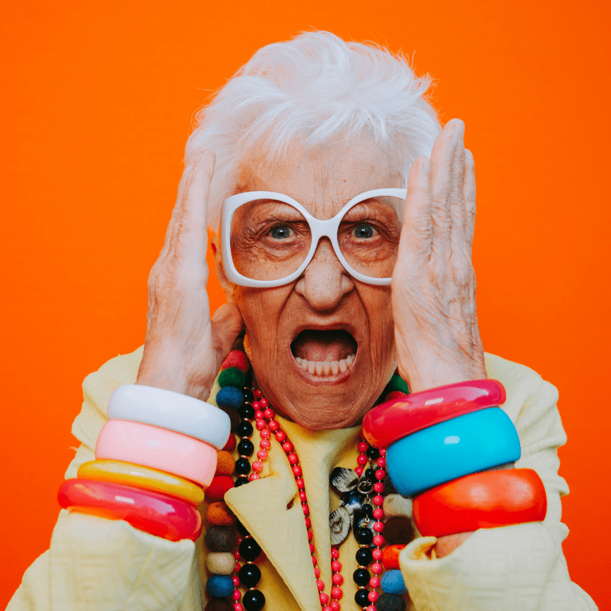 Elderly woman with expressive face, wearing large glasses and vibrant bangles